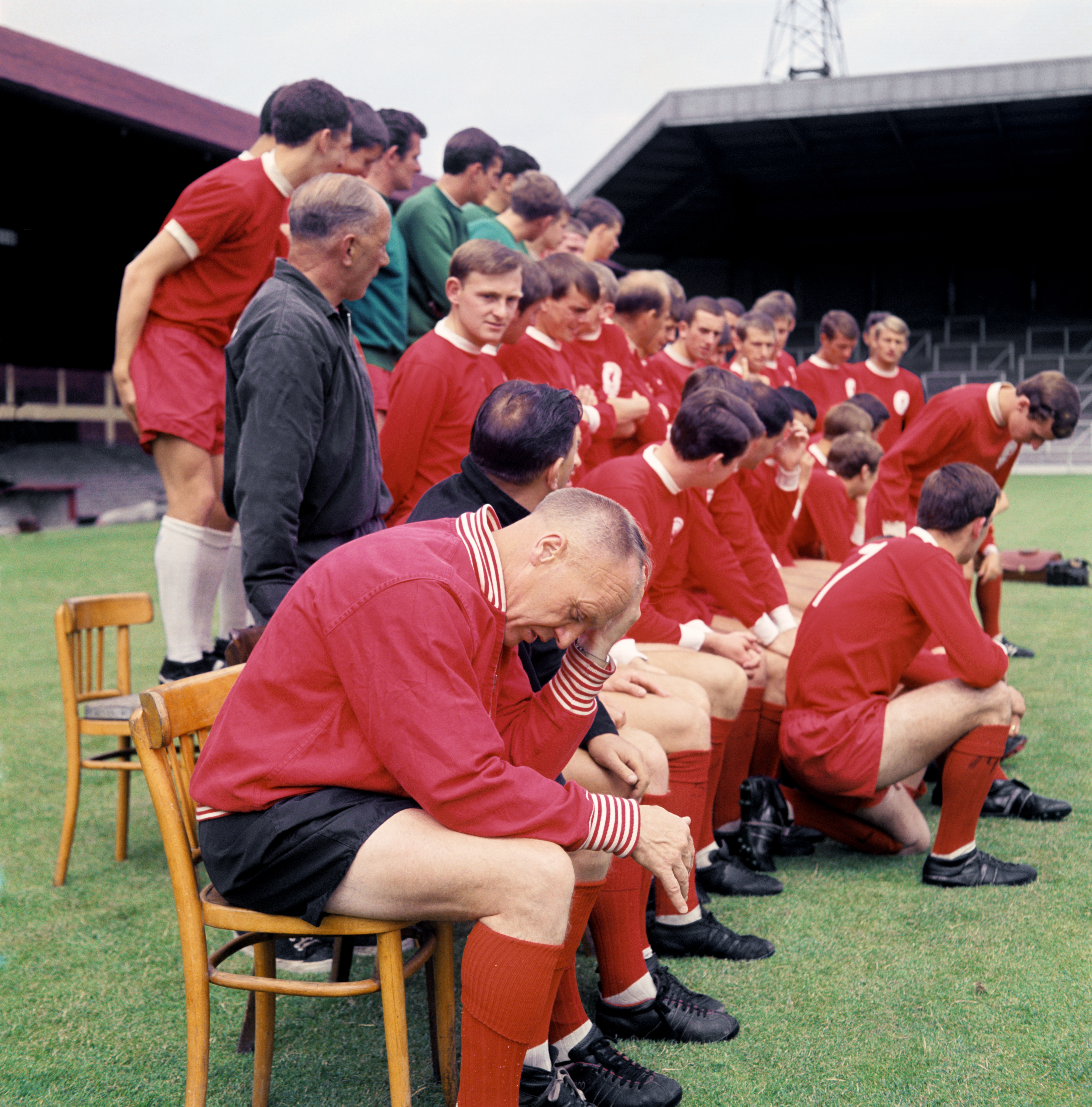 Liverpool manager Bill Shankly feels the stress of a new season as the players and coaches gather for a team group picture