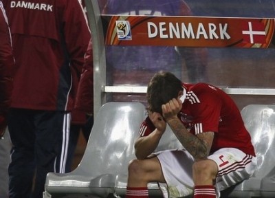 Denmark's Daniel Agger reacts on the bench after losing the 2010 World Cup Group E soccer match against Japan at Royal Bafokeng stadium in Rustenburg