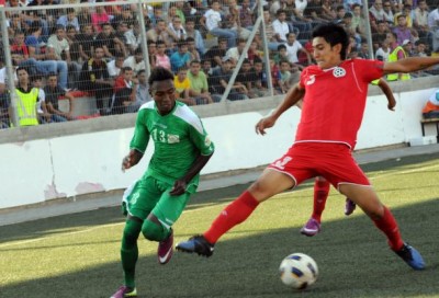 Palestines-Sulaiman-Obaid-fights-for-the-ball-with-a-player-from-Afghanistan-at-the-2014-World-Cup-first-round-soccer-match-in-A-Ram-in-the-West-Bank